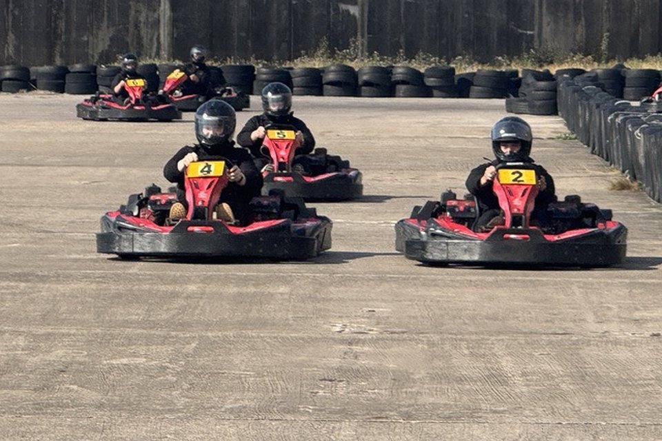 Three karts side by side on the straight at Formula Kart Blackpool