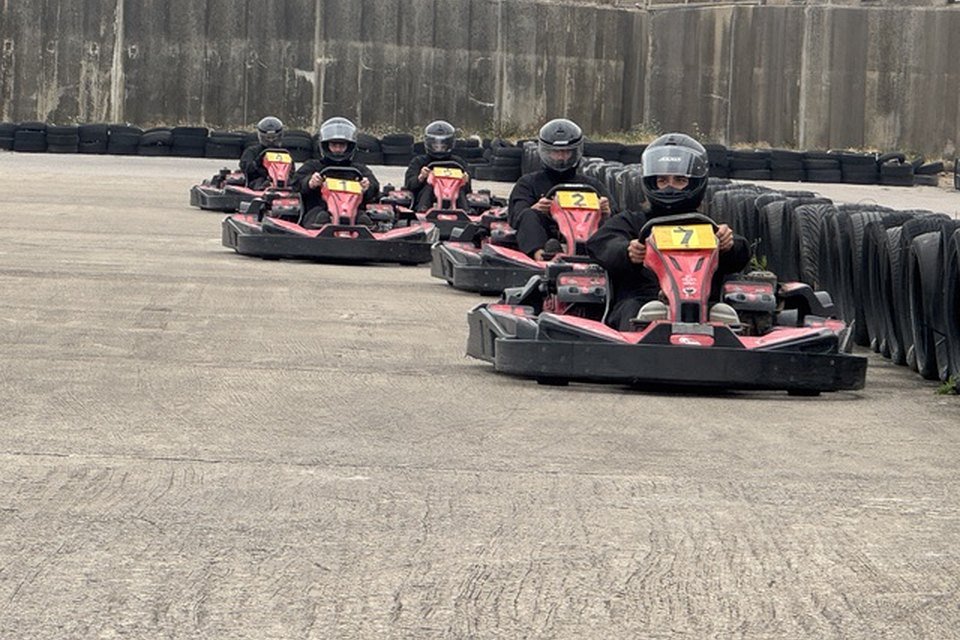 Karts on track at Formula Kart Blackpool, tyre barriers lining the circuit