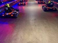 Karts on track at Gridline Racing under the venue lighting