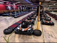 Row of electric SODI karts front-on in the pit lane at Gridline Racing