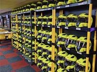 Helmet racks in the kit room at Gridline Racing