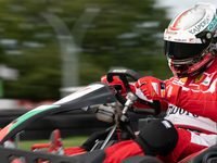 A driver leaning into a corner in a South Coast Karting kart