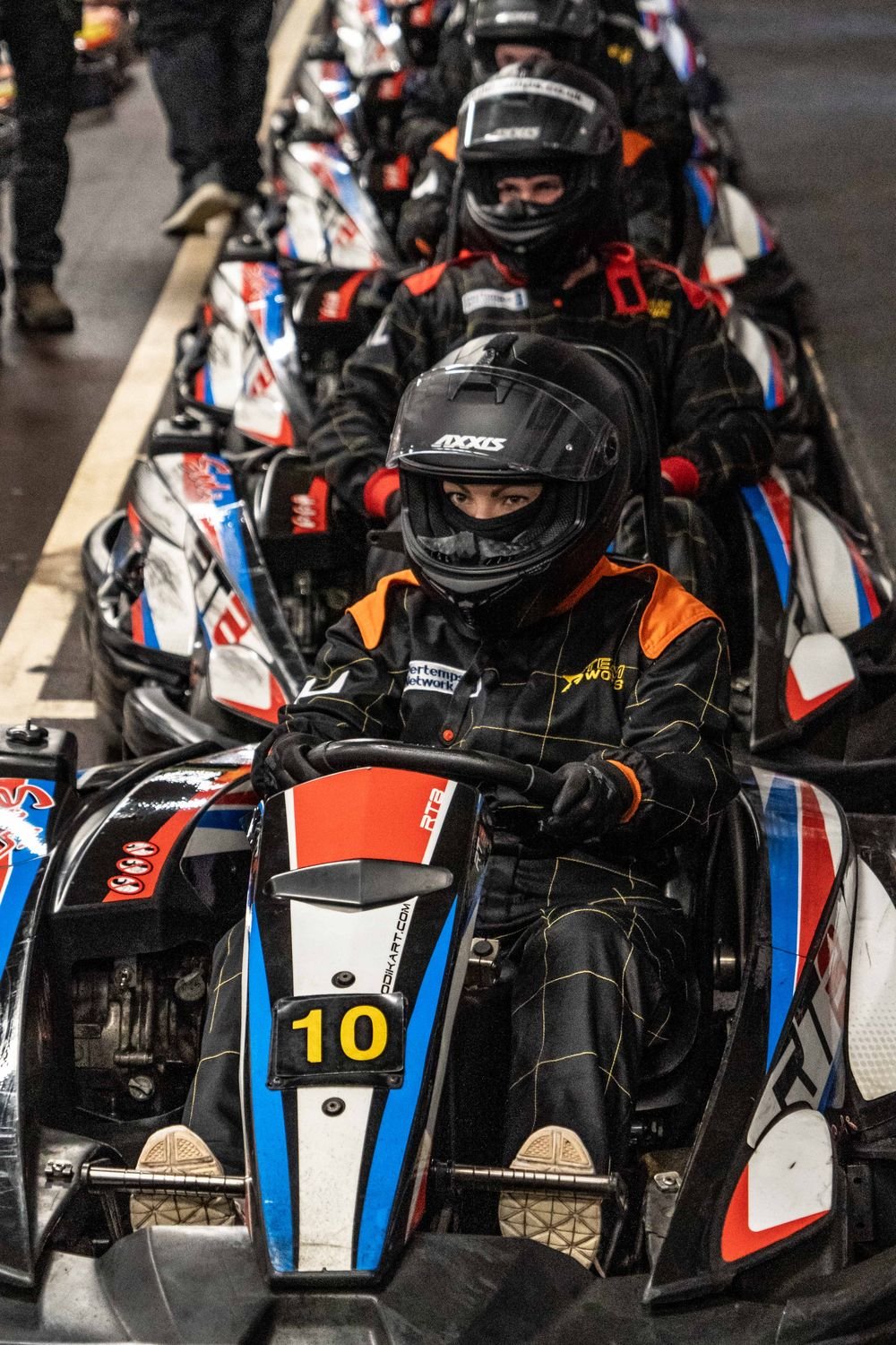 Drivers lined up in the pit lane at Teamworks Karting York waiting to go out